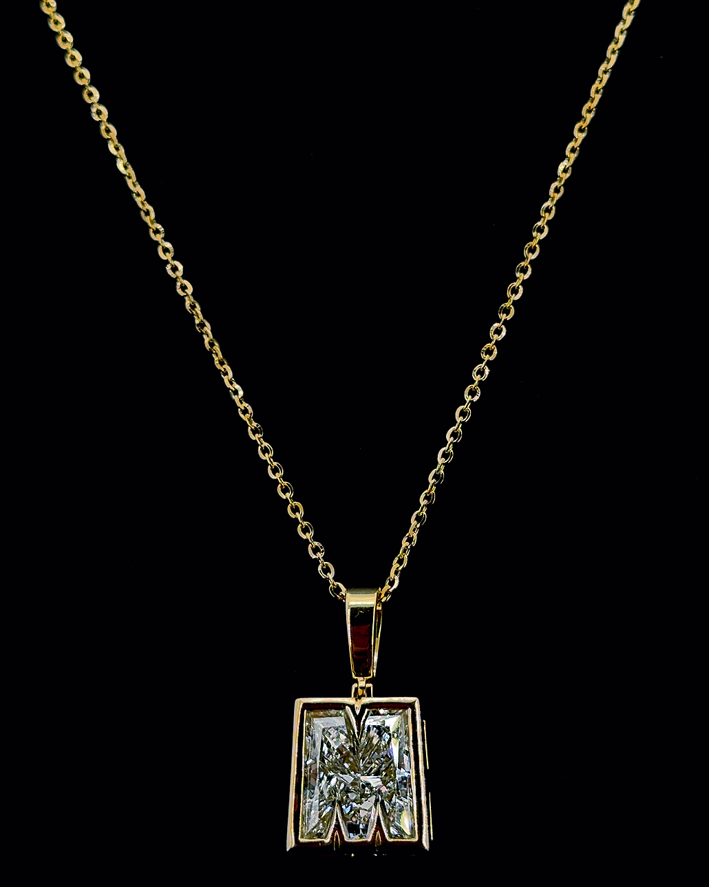 Yellow gold M-shaped lab-grown diamond pendant on a black background