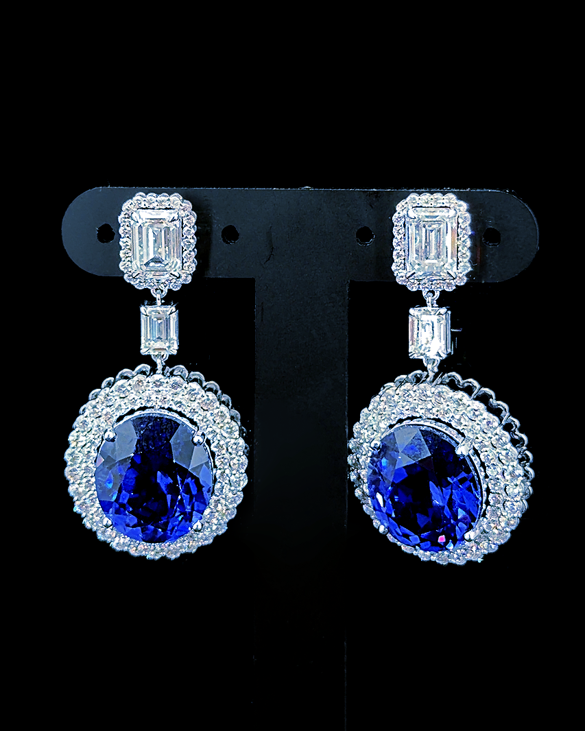 White gold blue oval birthstone earrings with double lab grown diamond halos on black
