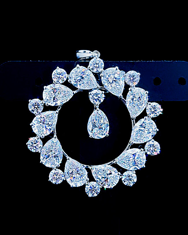 Main: White gold open halo pendant with pear and round lab grown diamonds on black
Detail: Close-up of pear and round lab grown diamonds arranged around an open circular pendant
Side: White gold statement pendant showing prong-set pear and round lab grown diamonds in profile
