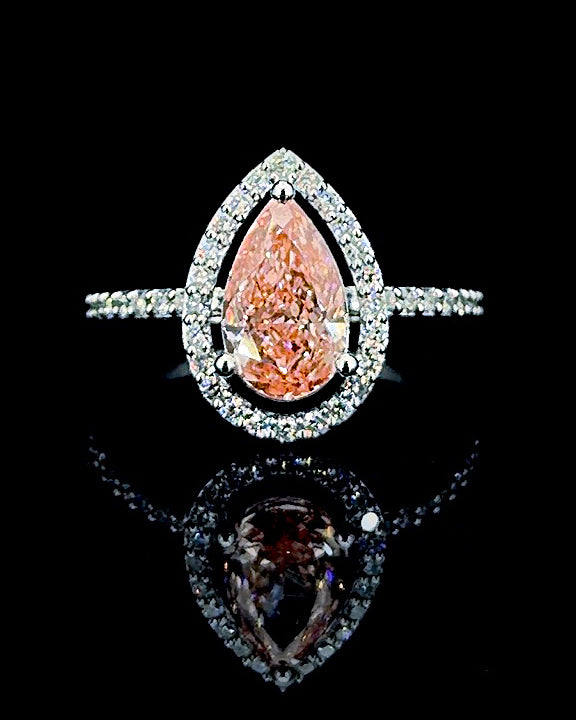 Main: White gold 1.74ct pink pear halo ring with pave lab grown diamonds on black
Detail: Close-up of 1.74ct pink pear lab grown diamond framed by a white gold diamond halo
Side: White gold pink pear ring showing raised halo setting and lab grown diamond pave shoulders