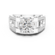 Silver ring with a large diamond and smaller diamonds on the band against a white background