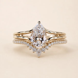 Pear Lab Grown Diamond bridal ring set in yellow gold featuring a cathedral solitaire engagement ring with a tiara contour wedding band.