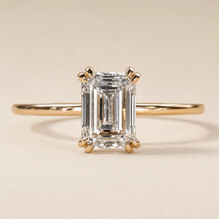 Emerald cut Lab Grown Diamond solitaire engagement ring in yellow gold with a double-claw four-prong cathedral setting.
