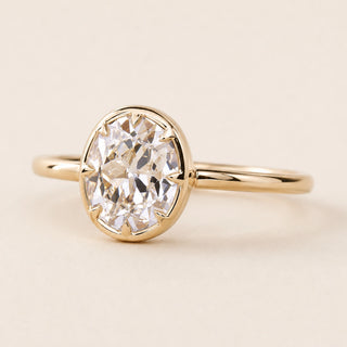 Cushion Old Mine Cut Lab Grown Diamond bezel engagement ring in yellow gold with an open basket gallery and comfort-fit shank.