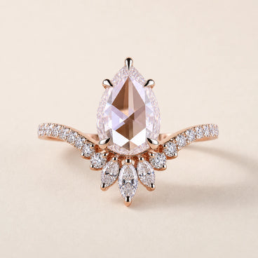 Pear rose cut Lab Grown Diamond nature inspired engagement ring in rose gold with pavé split shoulders and a floral marquise cluster.
