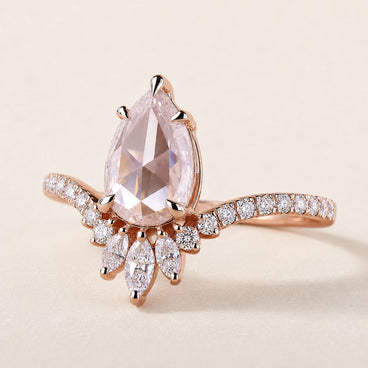 Pear rose cut Lab Grown Diamond nature inspired engagement ring in rose gold with pavé split shoulders and a floral marquise cluster.