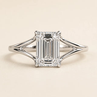 Emerald cut Lab Grown Diamond split shank engagement ring in white gold with a four double-claw prong cathedral setting.