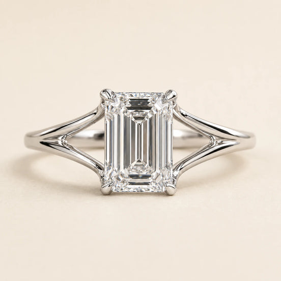 Emerald cut Lab Grown Diamond split shank engagement ring in white gold with a four double-claw prong cathedral setting.
