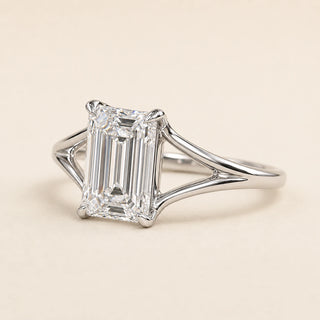 Emerald cut Lab Grown Diamond split shank engagement ring in white gold with a four double-claw prong cathedral setting.