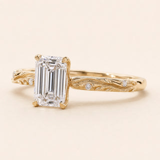 Emerald cut Lab Grown Diamond vintage engagement ring in yellow gold with a double-claw cathedral basket and engraved shank.