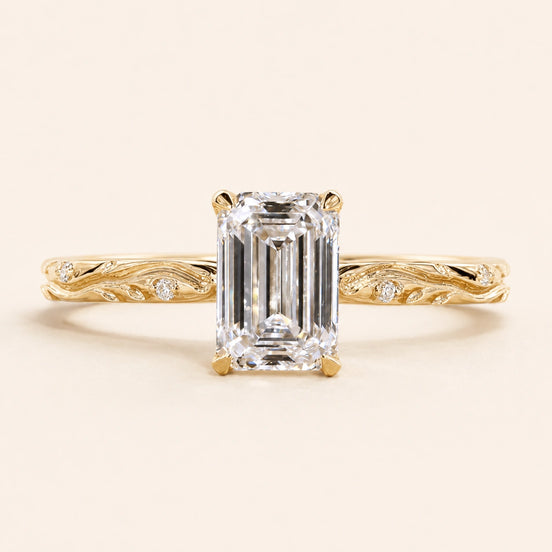 Emerald cut Lab Grown Diamond vintage engagement ring in yellow gold with a double-claw cathedral basket and engraved shank.