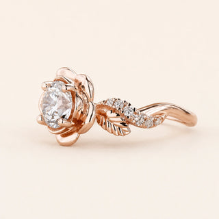 Round Lab Grown Diamond floral engagement ring in rose gold with a six-petal flower basket and leaf pavé shoulders.