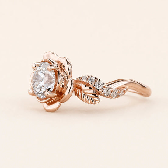 Round Lab Grown Diamond floral engagement ring in rose gold with a six-petal flower basket and leaf pavé shoulders.