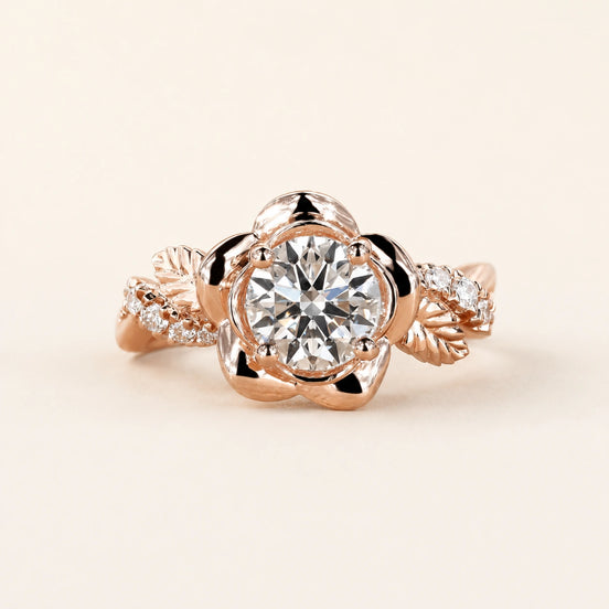 Round Lab Grown Diamond floral engagement ring in rose gold with a six-petal flower basket and leaf pavé shoulders.