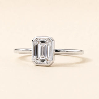 Emerald cut Lab Grown Diamond solitaire engagement ring in white gold with a four-prong open basket setting.