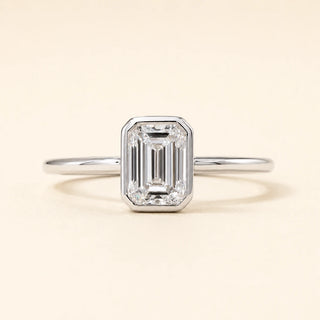 Emerald cut Lab Grown Diamond solitaire engagement ring in white gold with a four-prong open basket setting.