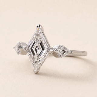 Lozenge step cut Lab Grown Diamond three stone engagement ring in white gold with matching lozenge side diamonds and double-claw prongs.