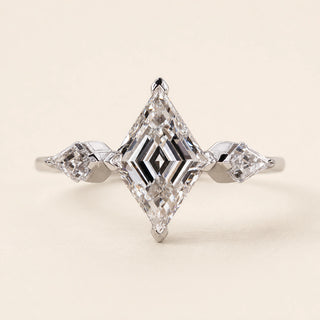 Lozenge step cut Lab Grown Diamond three stone engagement ring in white gold with matching lozenge side diamonds and double-claw prongs.