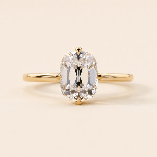 Cushion Old Mine Cut Lab Grown Diamond hidden halo engagement ring in yellow gold with a compass four-prong setting.