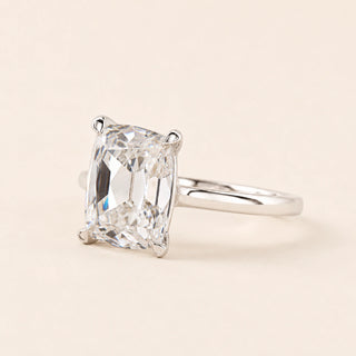 Cushion Old Mine Cut Lab Grown Diamond solitaire engagement ring in white gold with double-claw prongs and a cathedral basket.