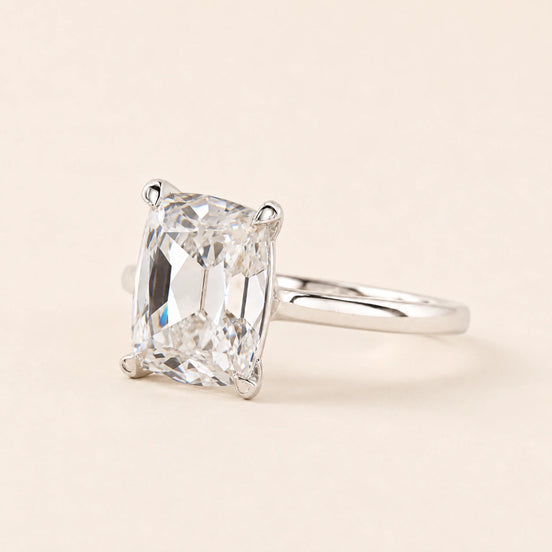 Cushion Old Mine Cut Lab Grown Diamond solitaire engagement ring in white gold with double-claw prongs and a cathedral basket.