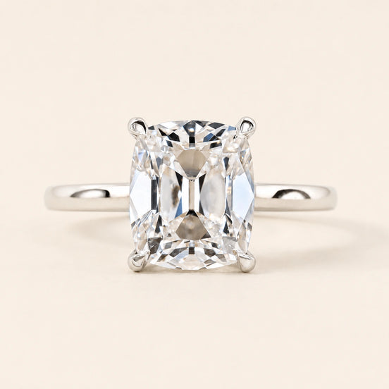 Cushion Old Mine Cut Lab Grown Diamond solitaire engagement ring in white gold with double-claw prongs and a cathedral basket.