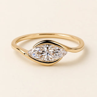 Marquise Lab Grown Diamond east-west solitaire engagement ring in yellow gold with a half-bezel bypass setting.