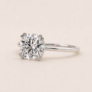 Round Lab Grown Diamond solitaire engagement ring in white gold with a six-prong cathedral basket diamond.