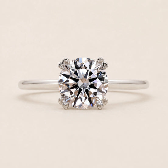 Round Lab Grown Diamond solitaire engagement ring in white gold with a six-prong cathedral basket diamond.