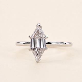 Long hexagon step cut Lab Grown Diamond solitaire engagement ring in white gold with a four-prong cathedral open basket.