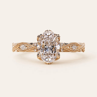 Oval Lab Grown Diamond vintage engagement ring in yellow gold with an Art Deco infinity shank, marquise and round diamond accents, and milgrain detailing.
