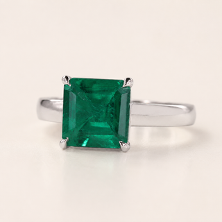 Green birthstone cathedral basket gemstone engagement ring in white gold