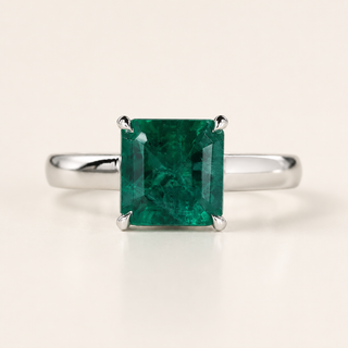 Green birthstone cathedral basket gemstone engagement ring in white gold
