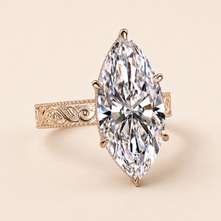 Marquise cut lab grown diamond vintage engagement ring in yellow gold with ornamental scroll shoulders