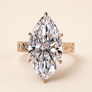 Marquise cut lab grown diamond vintage engagement ring in yellow gold with ornamental scroll shoulders