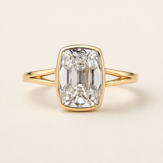 Cushion cut lab grown diamond bezel engagement ring in yellow gold with open split-shank shoulders