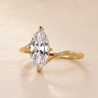 Marquise cut lab grown diamond bypass engagement ring in yellow gold with sweeping asymmetrical shoulders