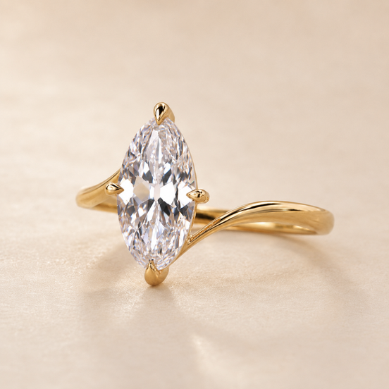 Marquise cut lab grown diamond bypass engagement ring in yellow gold with sweeping asymmetrical shoulders