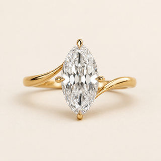 Marquise cut lab grown diamond bypass engagement ring in yellow gold with sweeping asymmetrical shoulders