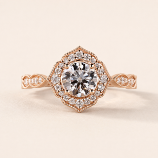 Round cut lab grown diamond halo engagement ring in rose gold with geometric pavé halo and twisted shoulders