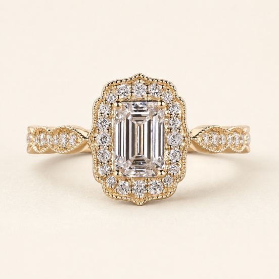 Emerald cut lab grown diamond halo engagement ring in yellow gold with rectangular pavé halo and twisted shoulders