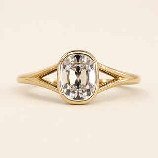 Cushion cut lab grown diamond bezel engagement ring in yellow gold with open split-shank shoulders