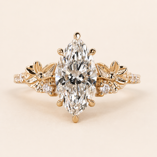 Marquise cut lab grown diamond floral engagement ring in yellow gold with sculptural flower-and-leaf shoulders