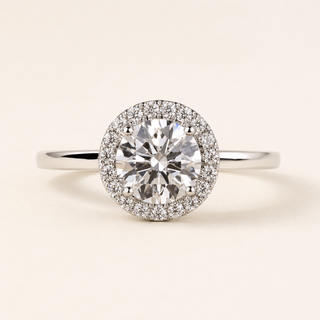 Round cut lab grown diamond halo engagement ring in white gold with cushion-outline pavé halo and plain band