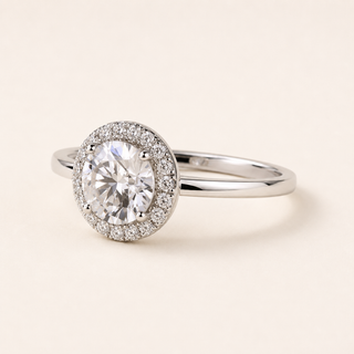 Round cut lab grown diamond halo engagement ring in white gold with cushion-outline pavé halo and plain band