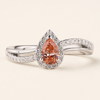 Pear cut pink Lab Grown Diamond halo engagement ring in white gold with split cathedral pavé shank