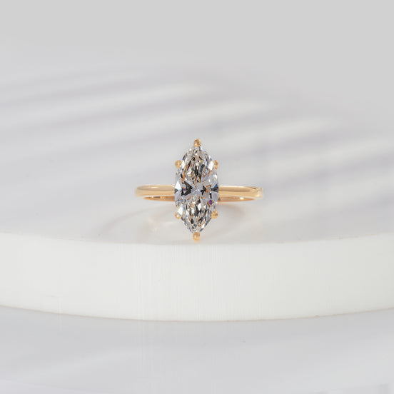 Marquise cut lab grown diamond solitaire engagement ring in yellow gold with six-prong setting and plain polished shank
