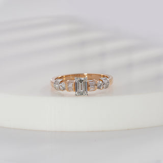 Emerald cut lab grown diamond side stone engagement ring in yellow gold with baguette and round diamond shoulders