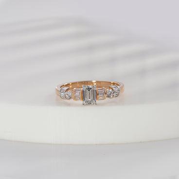 Emerald cut lab grown diamond side stone engagement ring in yellow gold with baguette and round diamond shoulders