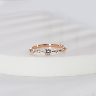 Round cut lab grown diamond side stone engagement ring in rose gold with graduated round diamond shoulders